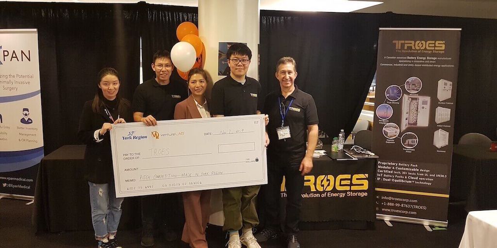 TROES wins investors pitching competition and poses with giant cheque
